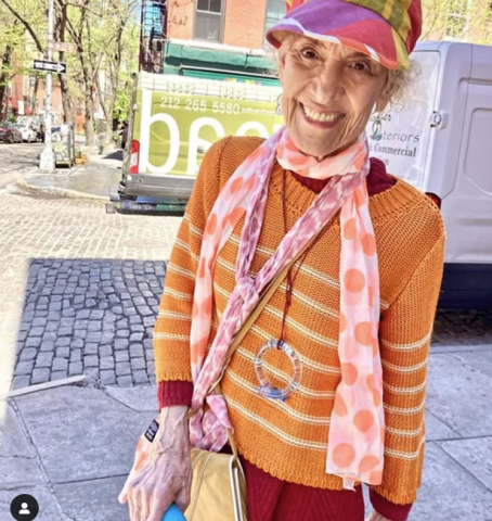 cousin jane in orange sweater with brightly colored hat